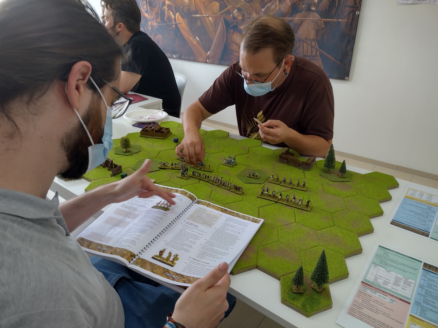 Consulting the rules during the Triumph! demo game